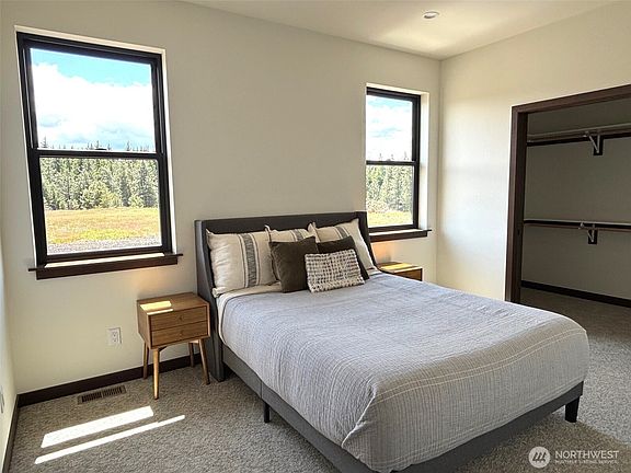 Primary suite, located on the main floor. This photo is of the model home.>