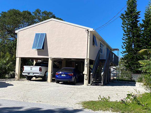 Front of house showing covered parking and storage as well as additional onsite parking space