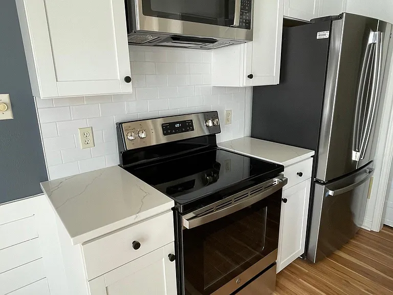 View of new stainless steel appliances and quartz countertops!