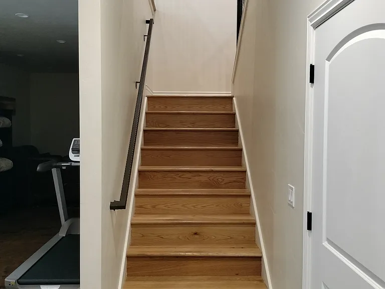 Wooden staircase to enter the office and media room.