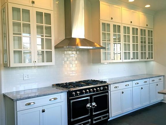 LaCornue range, stainless hood, under cabinet lighting and endless kitchen storage.