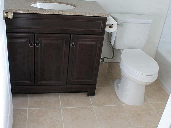 bathroom vanity/ toilet w/tile floor