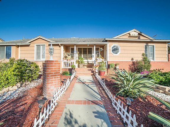 Inviting front yard cement brick ribbon walkway to