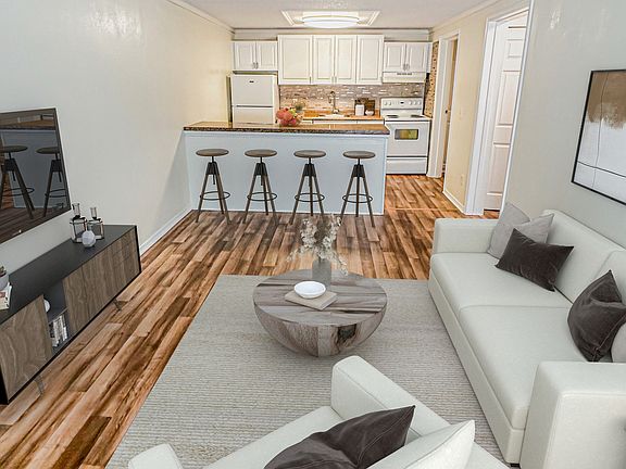 Relax in open-concept living rooms featuring vaulted ceilings that create an airy and expansive feel.