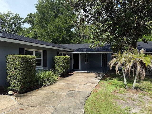 Private, rear unit, with a covered car port and room for a second car in the driveway.