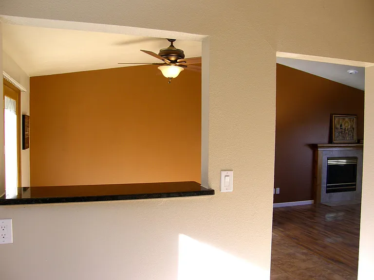 Kitchen bar opening to dining room with walkout