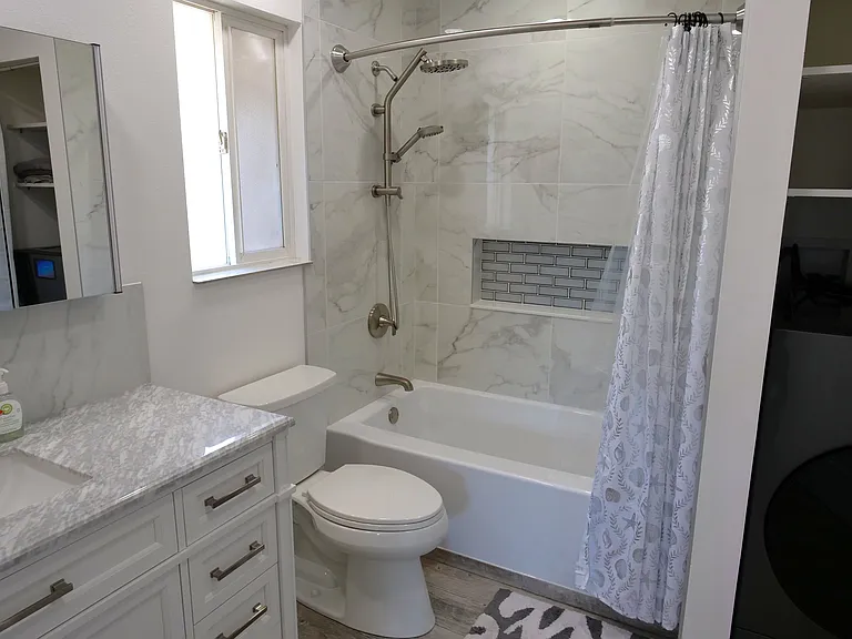 Large bright and airy bathroom with luxury soaking tub with built in Niche