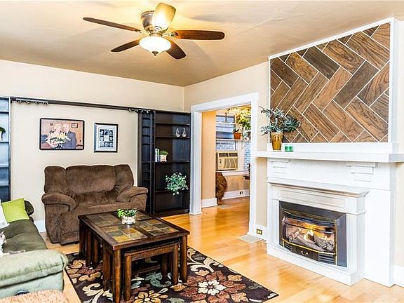 17x13 Living room with gas fireplace and wood floors.