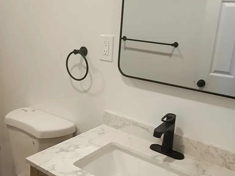 Contemporary wood vanity with granite top, large mirror and towel holder