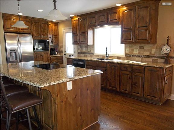 Kitchen area with newer Alder Cabinets, Granite Countertops, Pantry and Island/Bar.