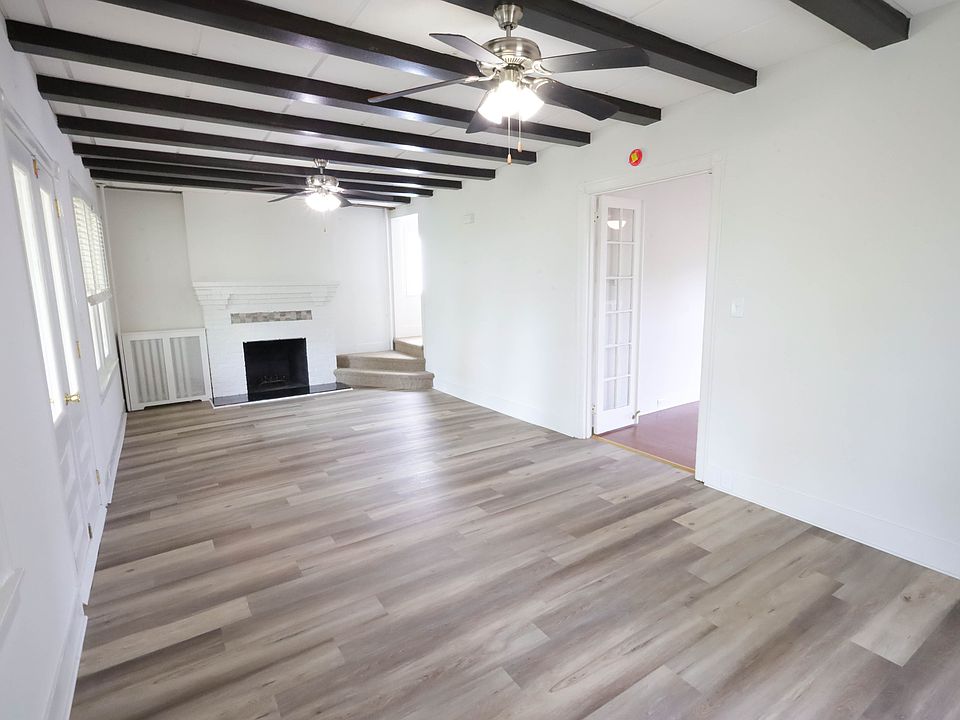 Living Room with Exposed Beams and Fireplace