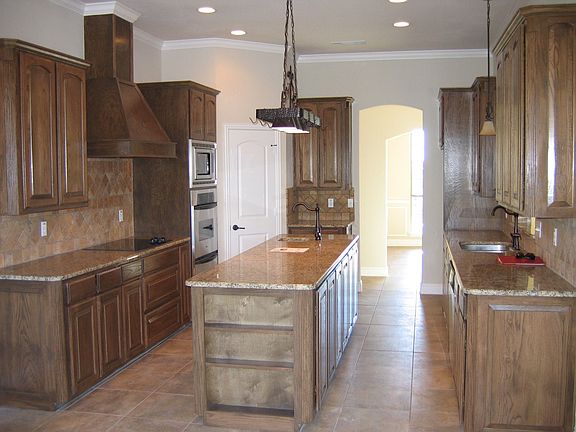 Elegantly designed kitchen features granite countertops, built in double oven, microwave.