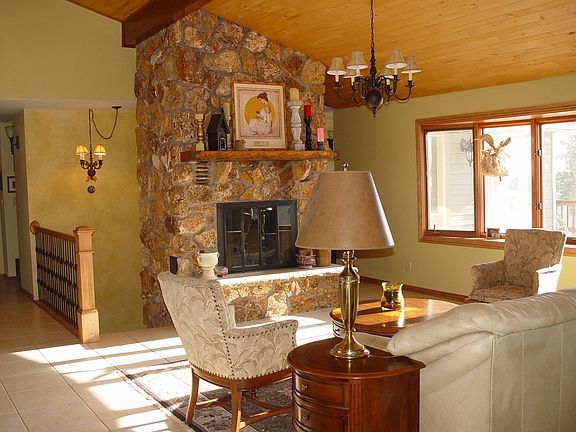 Great Room with Stone Fireplace, Vaulted Wood Ceiling and Large Bay Window