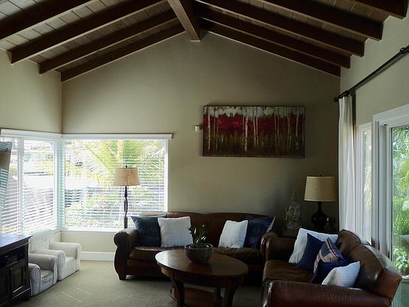 Living room with vaulted beam ceiling. Vista ocean views from the left side living room window.