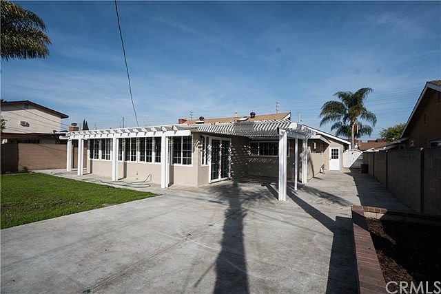 Beautiful backyard with enclosed patio, perfect for summer BBQ