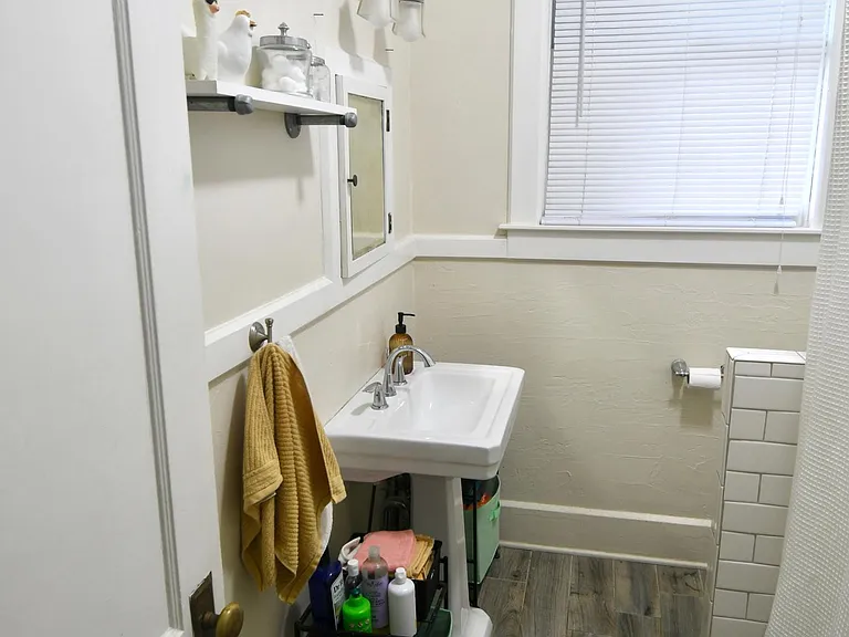 Bathroom with Pedestal Sink and Subway Tile in Shower Area