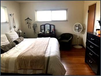 Master bedroom, walk-in closet door at right rear. Both windows onto the back yard garden.