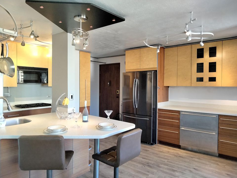 Custom executive kitchen, opens to living room and view from lanai. Large capacity refrigerator.