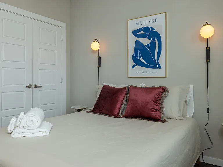 Bright and airy primary bedroom with a cozy queen bed, flooded with natural light_your perfect retreat for rest and relaxation. This bedroom is located on the first floor.
