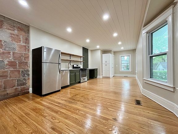 Wide open floor plan with refinished hardwood floors