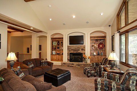 Great room with soaring ceilings, stone fireplace, built-ins