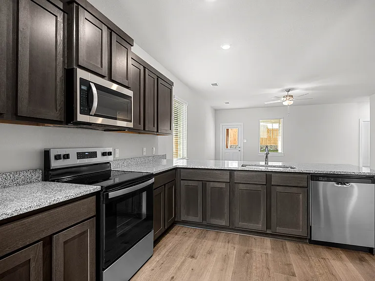 The kitchen has beautiful wood cabinetry.
