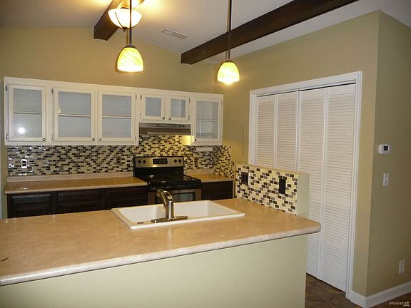 Updated kitchen with tile back splash. Awesome bar area.