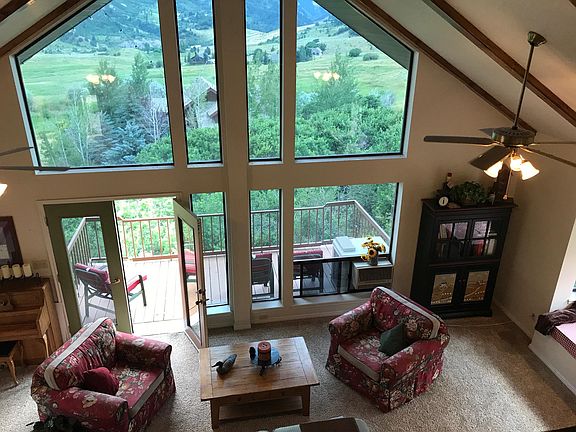 Beautiful vaulted living room with large south facing windows and deck