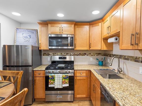 Full Kitchen with all brand-new appliances, granite countertop, equipped with utensils and pots and dishes and glasses, toaster, and coffee maker.