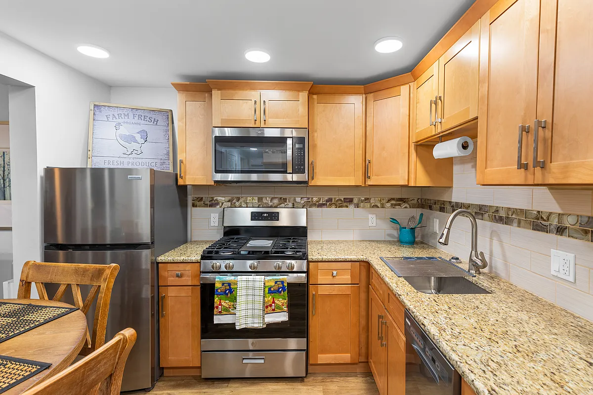 Full Kitchen with all brand-new appliances, granite countertop, equipped with utensils and pots and dishes and glasses, toaster, microwave, and coffee maker. - 7849 Kellogg St #1