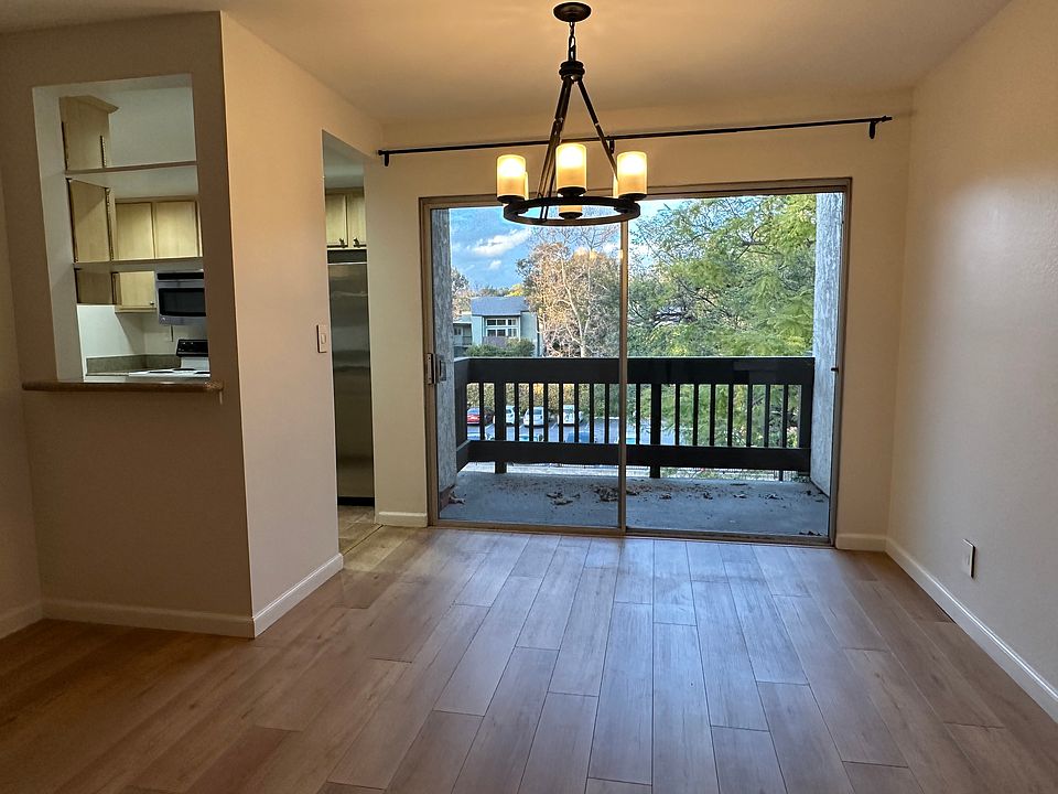 Dining area and private balcony with treetop view!
