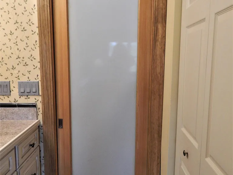 With a light touch, the pocket door glides smoothly on its custom track to automatically retract into its pocket.