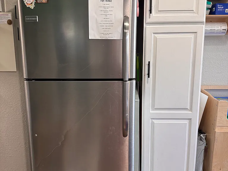 Kitchenette and basement. Full-size refrigerator and cabinet that is like a pantry with pullout drawers.