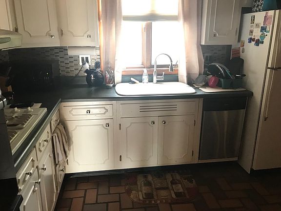Kitchen with dishwasher, fridge has new icemaker, updated fixtures.
