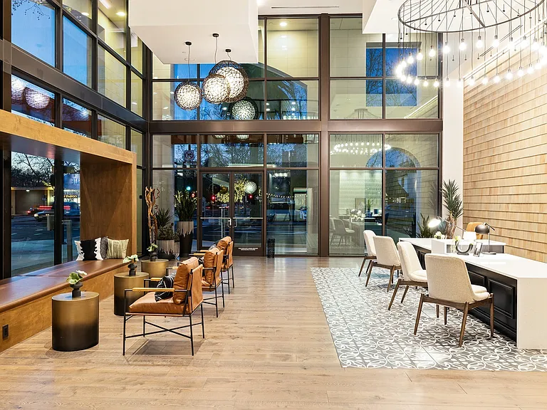 Stylish and spacious lobby featuring modern furnishings, natural light, and a welcoming atmosphere for residents and guests.