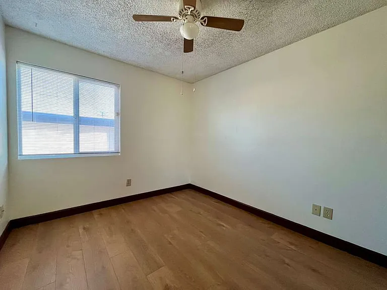 West smaller bedroom, newly-installed wood laminate flooring and new mini-blinds