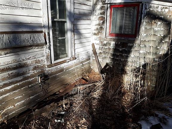 South side of property, damaged siding and foundation