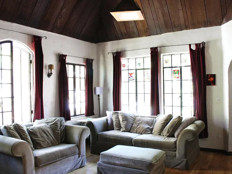 Sunny, spacious living room with hardwood floors