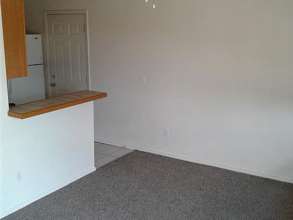 Living area with kitchen bar and back yard access