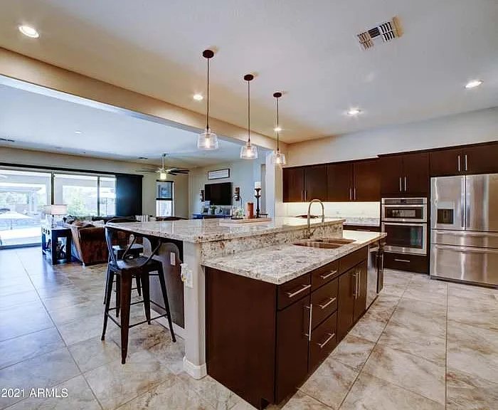 Two-tiered granite makes this kitchen functional and welcoming--everyone gathers here whether you intend it or not!