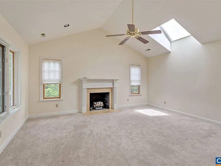 The master bedroom has a cathedral ceiling and a skylight. The fireplace is gas. You have direct access to the upstairs porch on the left, and on the right is a small balcony overlooking the pool, perfect for keeping an eye on the kids.