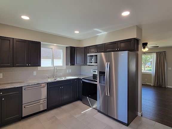Brand New Kitchen Cabinets with Full-Overlay and Soft-close doors. All New stainless appliances including a Fisher & Paykel Double Drawer Dishwasher and Counter Depth Fridge. Quartzite countertops. New Tiled floor and backsplash. Stainless steel sink.