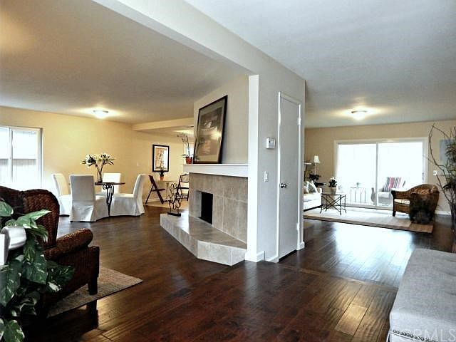 Beautiful 2 sided fireplace accented by real hardwood slightly distressed floor.
