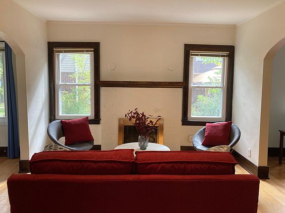 View of the living room, fireplace, and seating area.