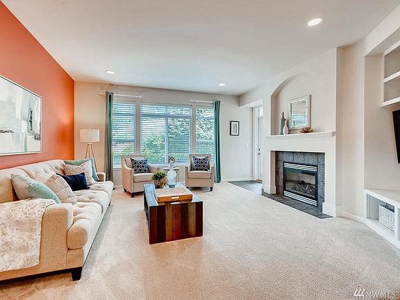 Beautiful living space with lots of natural light, a gas fireplace, media center and views to the lush backyard.