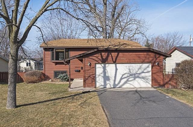 Nice looking split entry with updated mechanicals, new roof, new exterior window wraps, sprinkler system & low maintenance, attractive landscaping