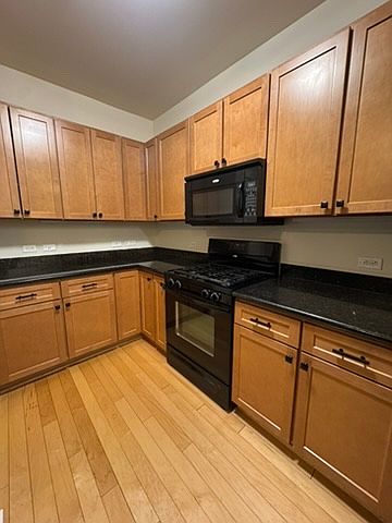 Beautiful wide open Kitchen, with microwave, stove, dishwasher, and fridge.