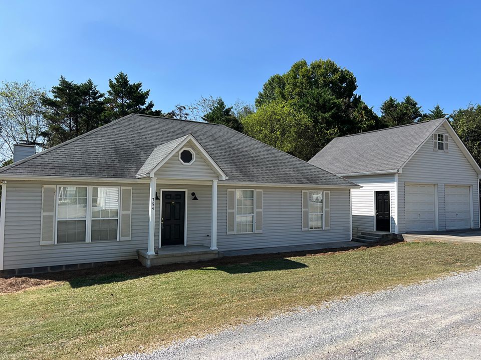 Front of house with detached two car garage with unfinished loft for storage
