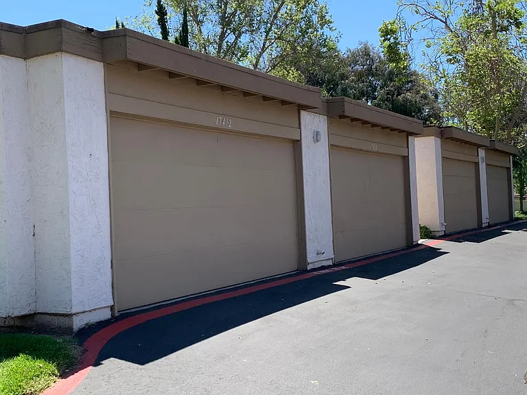 Large two car garage with storage shelving.