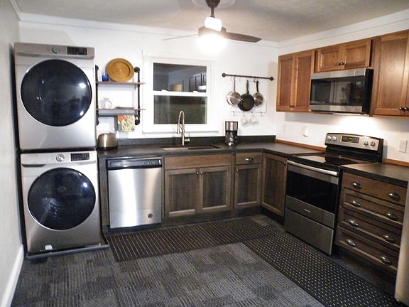 All new appliances in kitchen. Samsung front loading washer/dryer combo. Amana dishwasher, flat top range. Granite countertops and new Haas top of line hickory cabinets. Kraus 30 inch sink center.